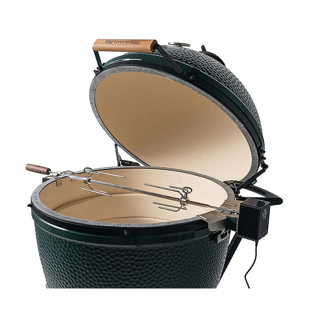 XL Big Green EGG rotisserie kit set up inside and XL Big Green EGG. Brackets on each side, spit running across and motor attached.