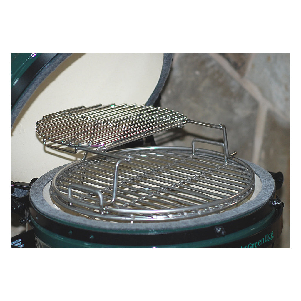 Angled top view of sliding second grid bundle on Small CGS Woo in Small Big Green Egg. The top grid is pushed back showing how to access the lower grid on the Woo.
