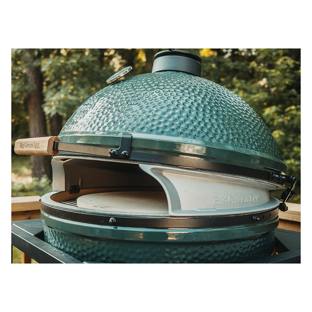 Angled view from the side of the XL Big Green EGG set up with the XL Pizza Wedges (sku 136688). Dome is closed and pizza stone is visible through wedge opening and about 1 inch below felt line.